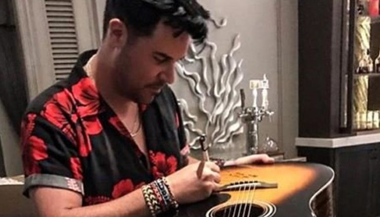 Frankie Moreno Autographing his guitar